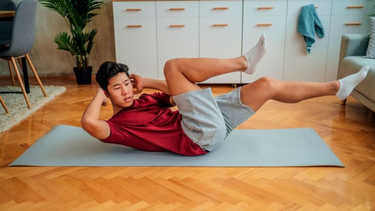 Man performs bicycle crunch at home