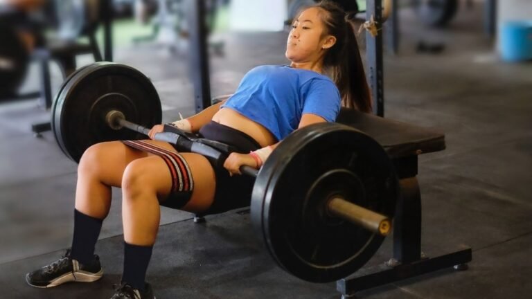 Woman performs barbell hip thrust