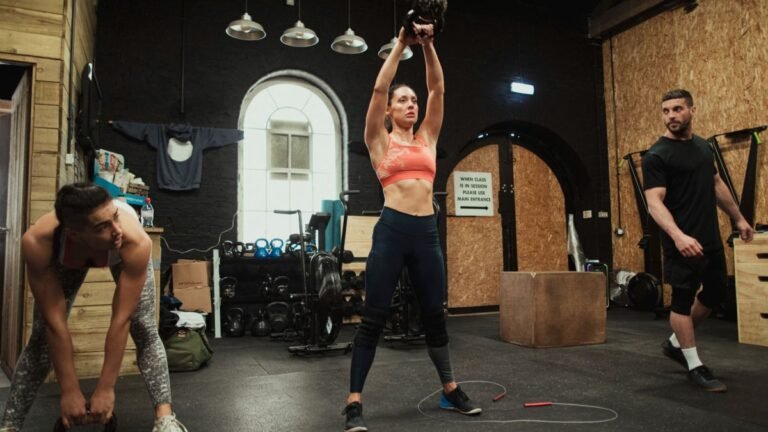 Athletes using kettlebells in a CrossFit box