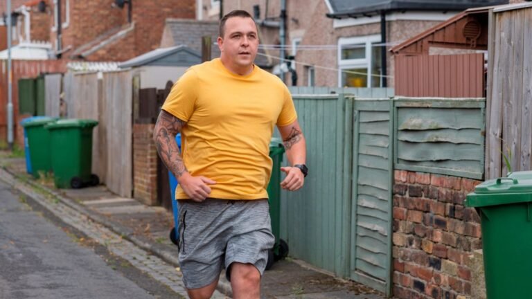 Man running next to houses