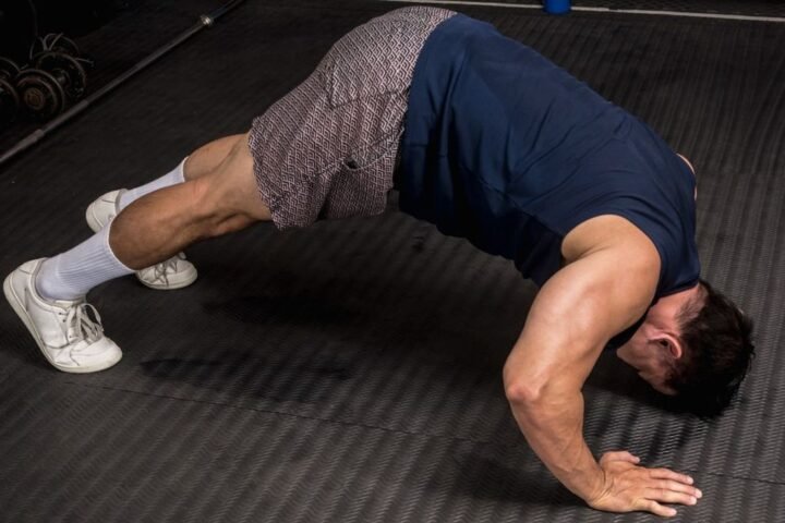 Man performs pike press-up