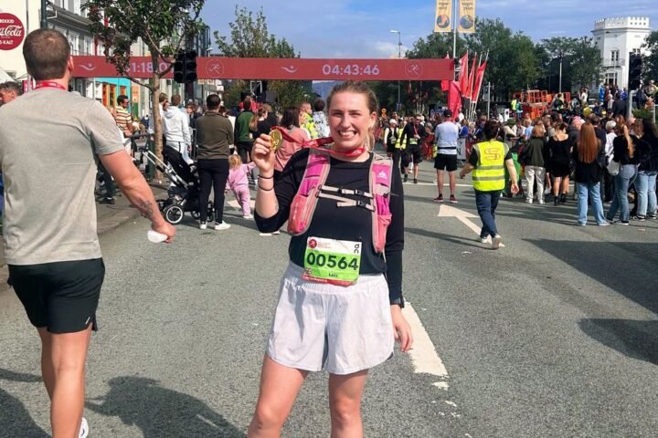 author posing with marathon finishers medal