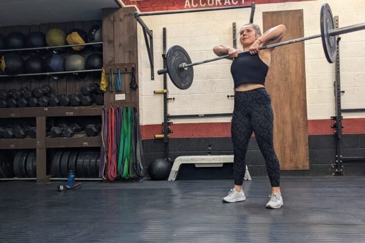 Emma Ray demonstrates the squat part of the barbell thruster