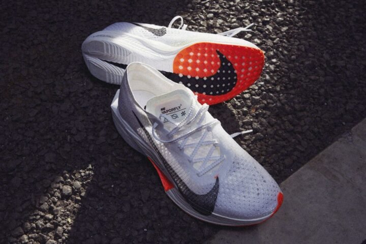 Nike Vaporfly NEXT% 3 running shoes on Tarmac, one shoe is on its side to show the outsole