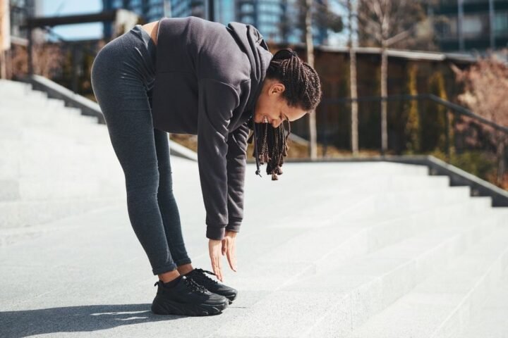 Woman performs roll down exercise