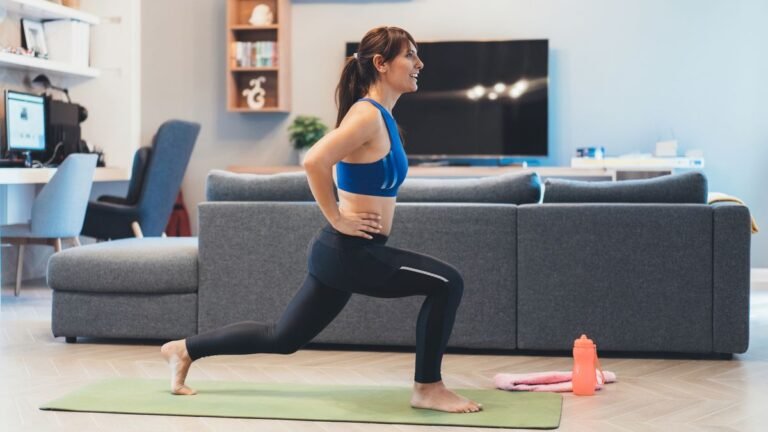 Woman performing lunge exercise in living room