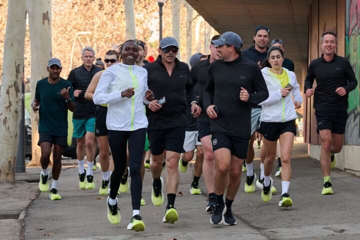 Sharon Lokedi running with a pack of journalists