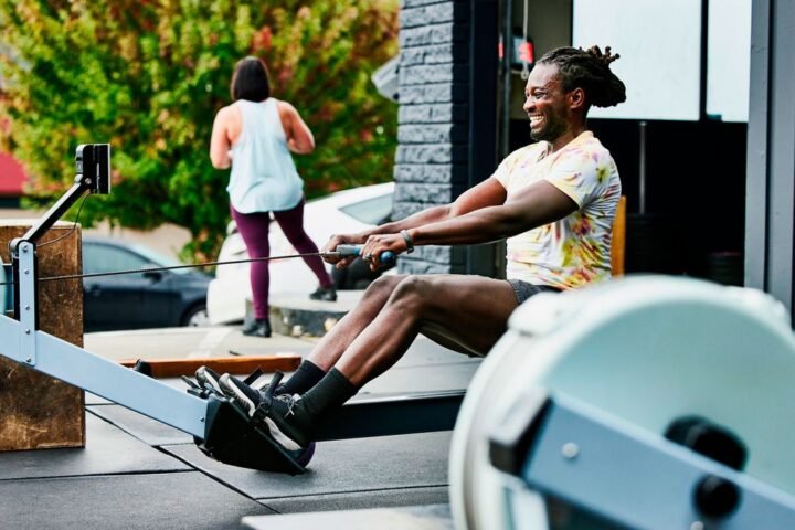 Man using rowing machine outside a CrossFit box