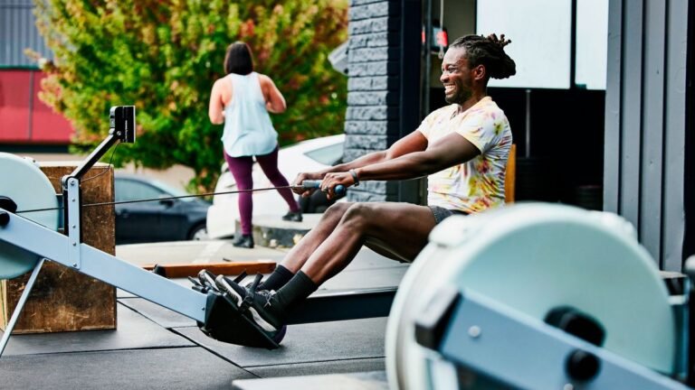 Man using rowing machine outside a CrossFit box