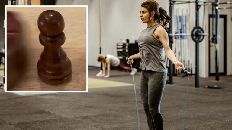 A woman performing double-unders in a CrossFit box, and Dave Castro