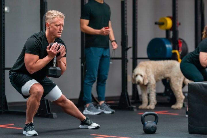 Man performing side lunge holding dumbbell